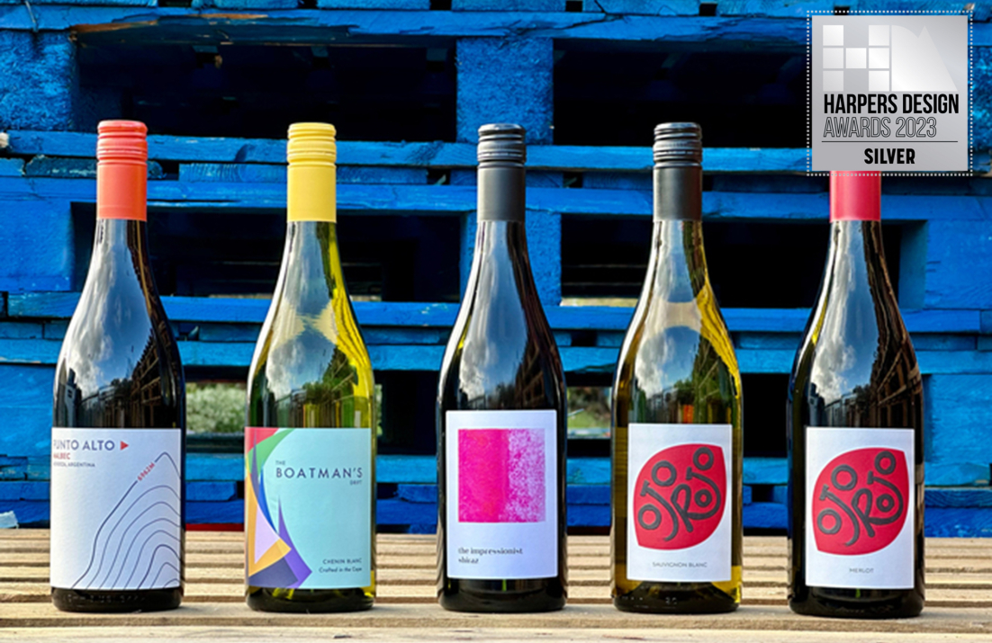 Five wine bottles lined up on wooden crate