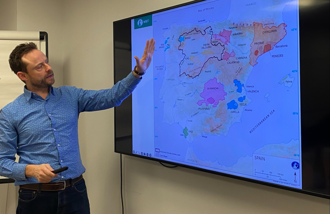 Jonny pointing at wine map on a screen