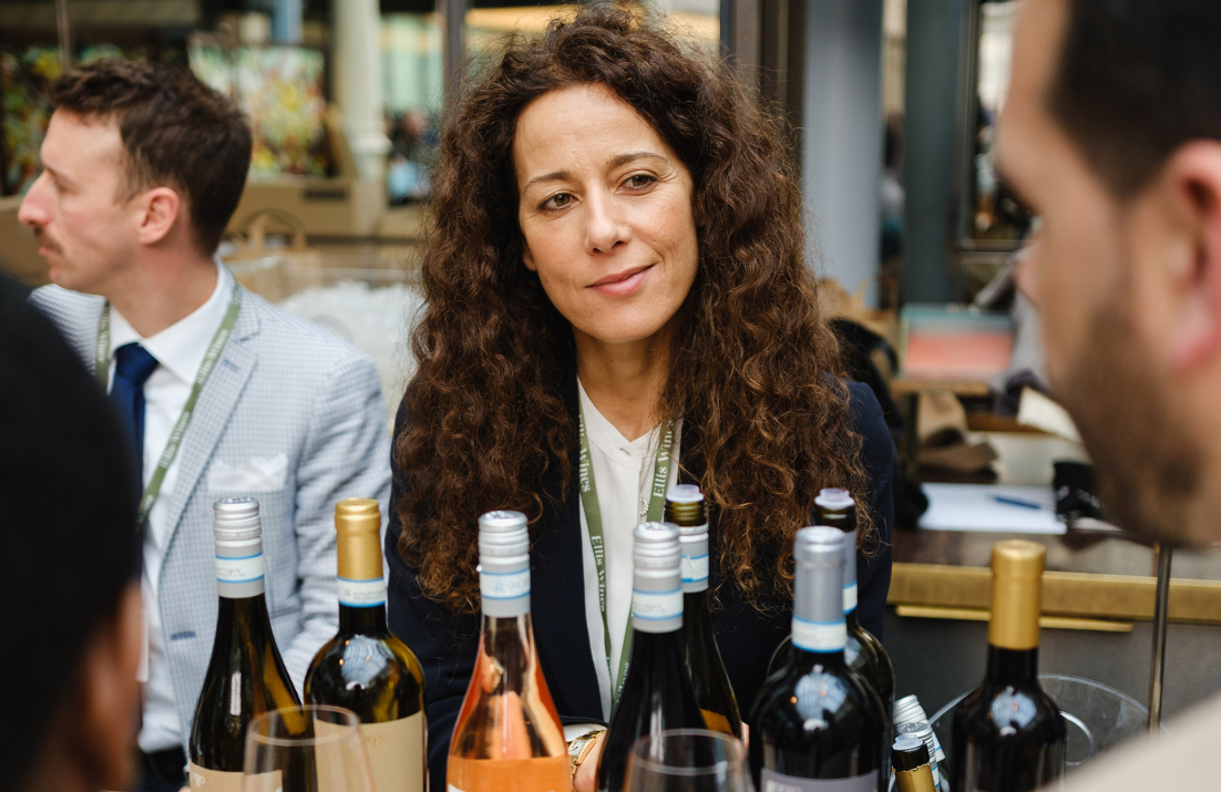 Roberta Bricolo standing behind counter of wine bottles