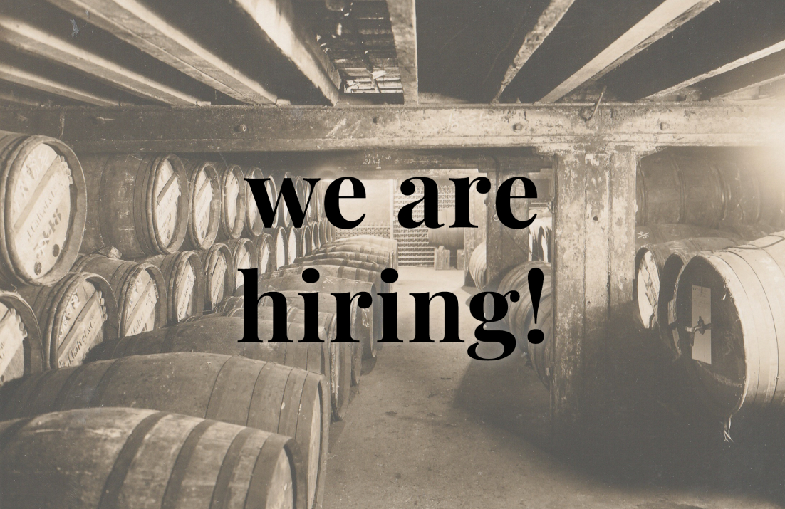 Barrels in cellar with overlay text: we are hiring