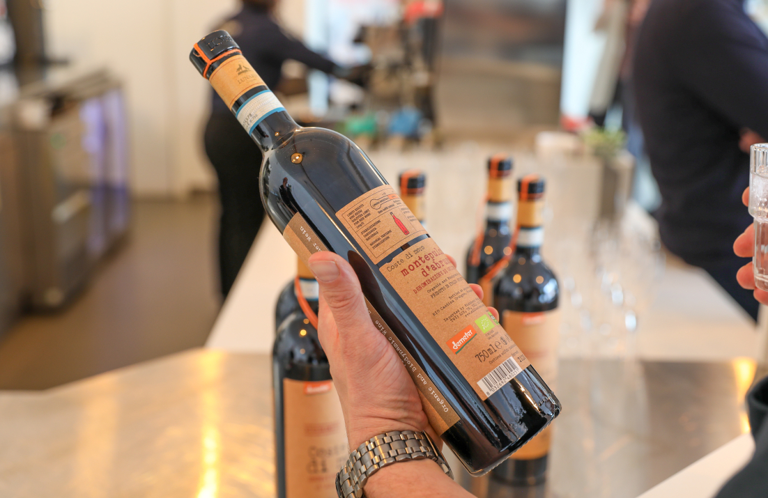 holding a wine bottle