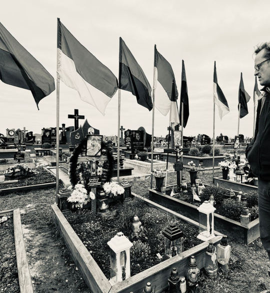 Richard Yates overlooking cemetery with Ukranian flags