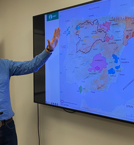 Jonny pointing at wine map on a screen