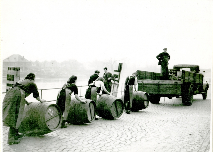 Ladies moving wine barrels